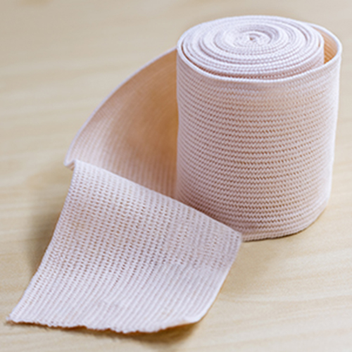 Medical elastic bandage on wood table. Medical elastic bandage